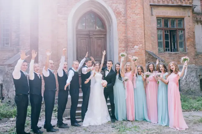 Wedding party laughing together outside a city hall after a courthouse ceremony