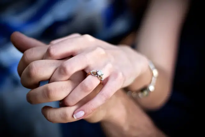 Couple sitting together reviewing wedding plans and having a conversation before their ceremony