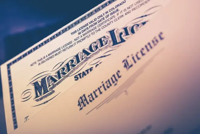 A couple reviewing legal documents together after getting married at a California courthouse