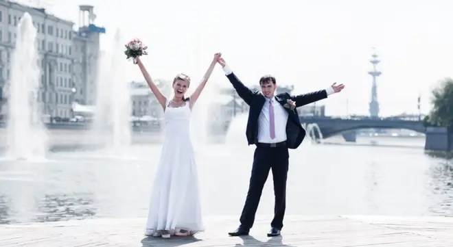 Bride and groom laughing together at a small intimate wedding ceremony outdoors