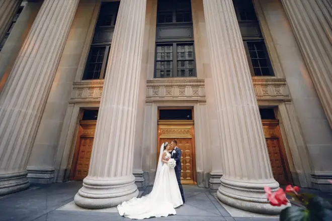 Couple holding hands outside a courthouse after their wedding ceremony