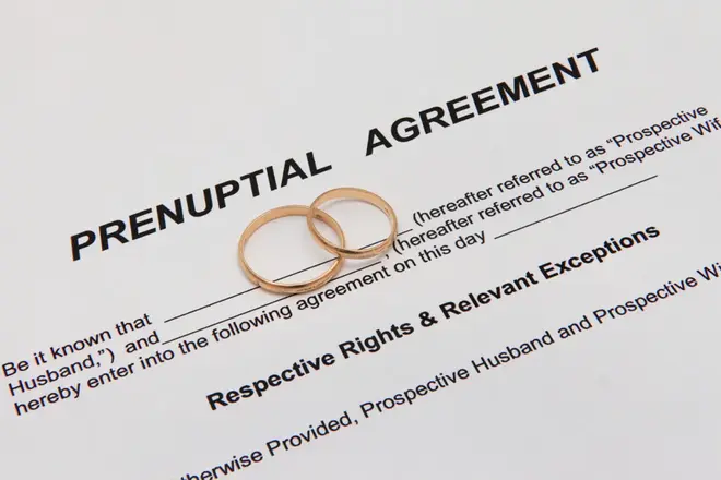Couple reviewing a prenuptial agreement document together before their wedding