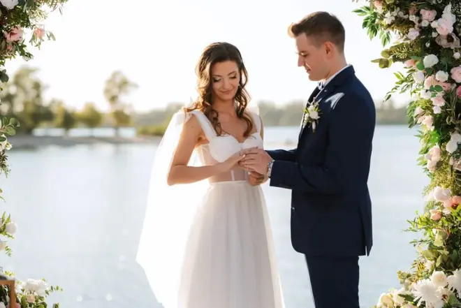 Couple holding hands during a vow renewal ceremony outdoors